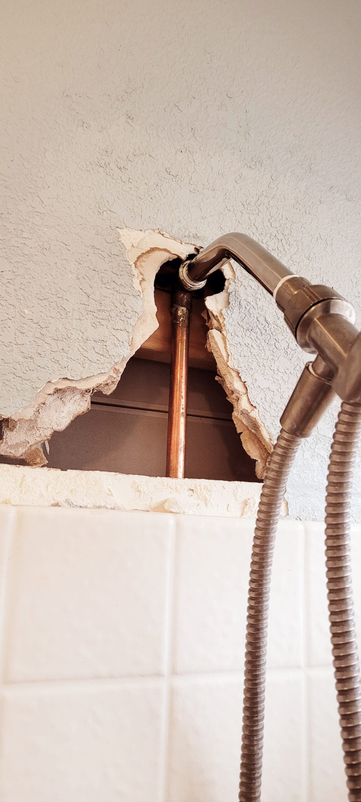 repairing the wall behind a leaky shower