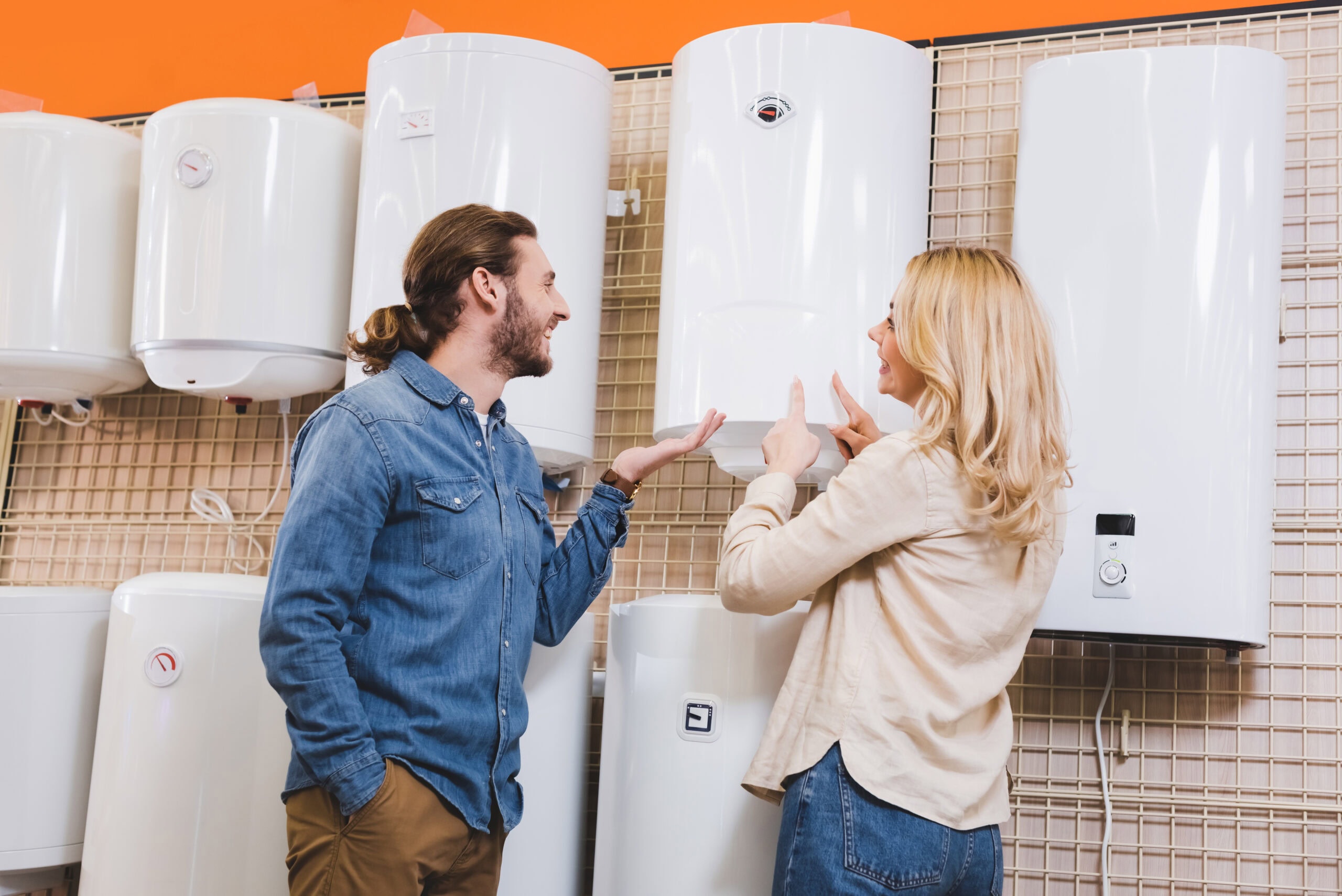 smiling couple shopping for affordable hot water heater systems